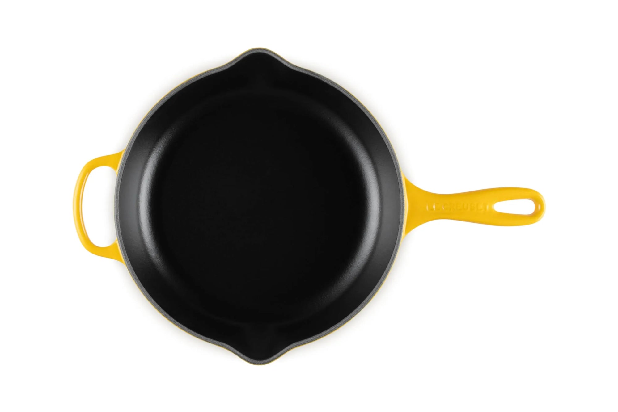 A top-down view of a cast iron skillet with a black interior and bright yellow exterior handles, isolated on a white background.