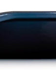 Side view of a dark blue cast iron skillet with a long handle, shown from a side profile view against a white background.