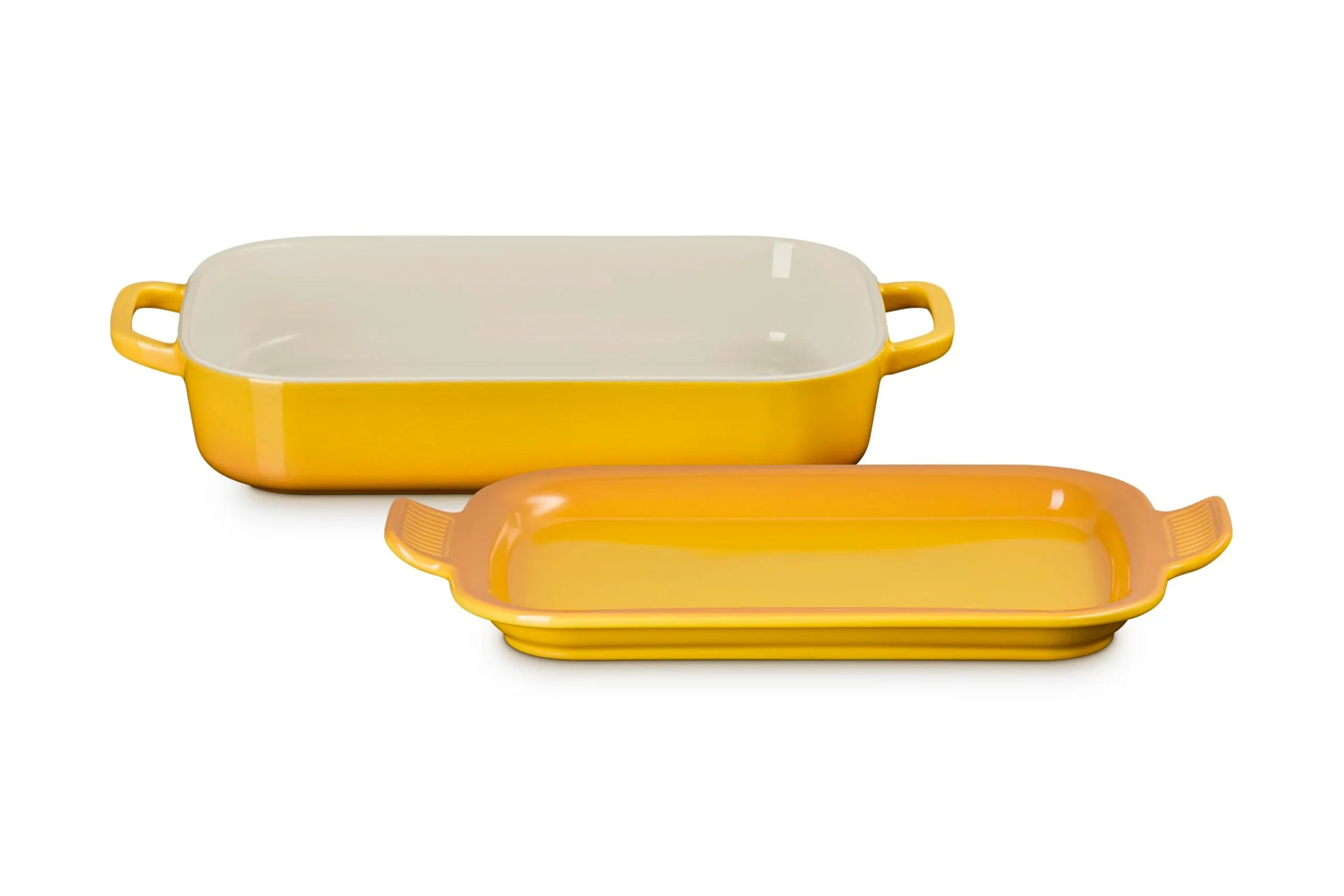 A rectangular yellow ceramic baking dish with a matching lid, shown on a clean white background. The inside of the dish is cream-colored.