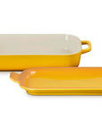 A rectangular yellow ceramic baking dish with a matching lid, shown on a clean white background. The inside of the dish is cream-colored.