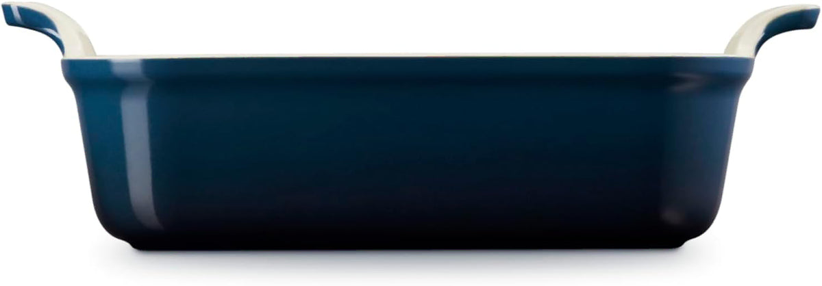 Side view of dark blue Le Creuset 3 qt Heritage Square Dish displayed on a white background