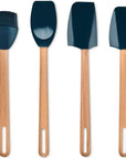 Four silicone kitchen utensils with light wood handles, including a basting brush, a spoon, a scraper, and a spatula, shown on a plain white background.