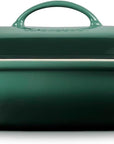 Side view of green oven dish with a lid on a white background