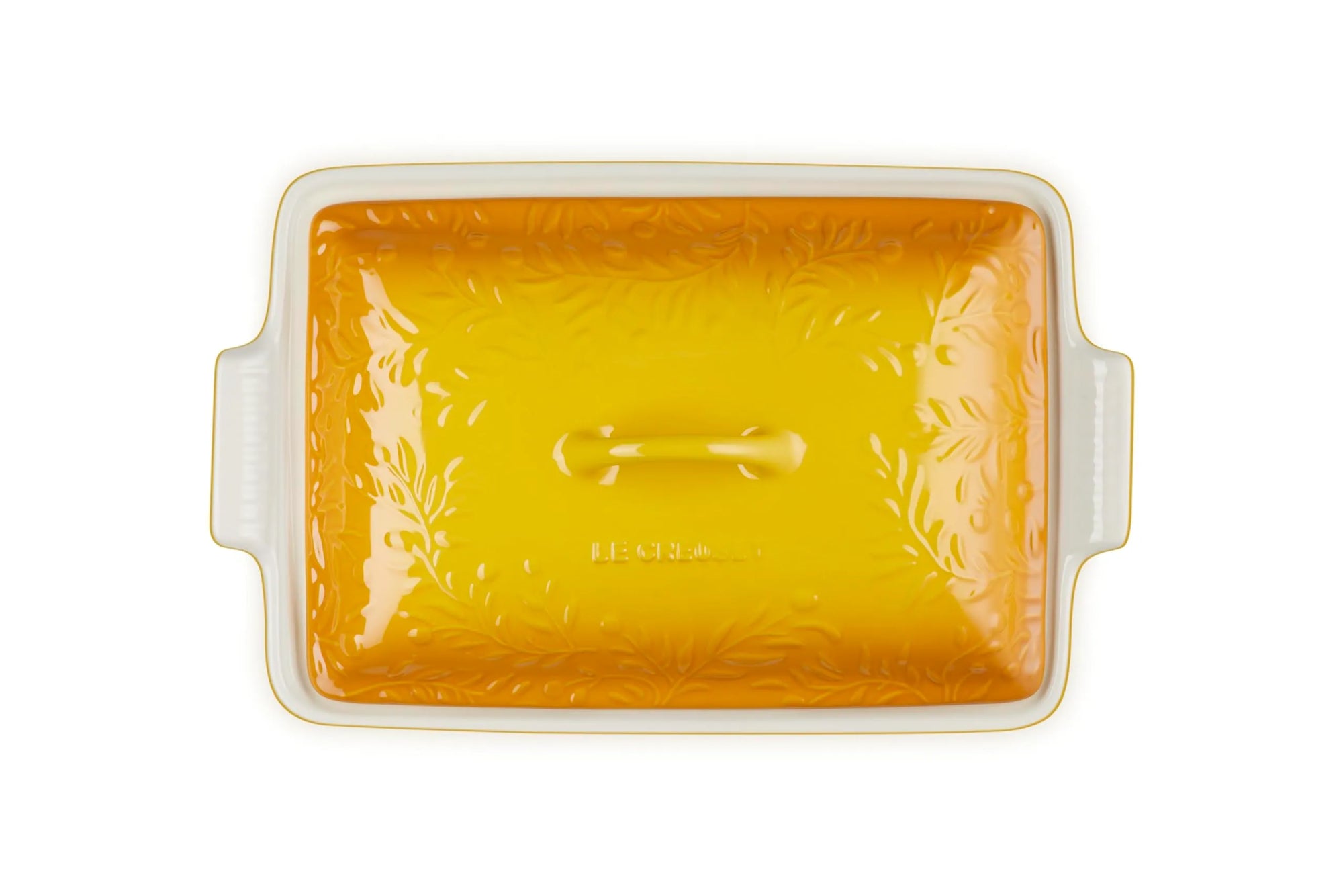 A rectangular glass baking dish with a lid, featuring a vibrant yellow-orange floral pattern on the lid and a white glass base with side handles, shown on a solid white background.