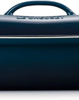 Side view of dark blue Le Creuset 4 qt Stoneware Heritage Covered Rectangular Casserole displayed on a white background