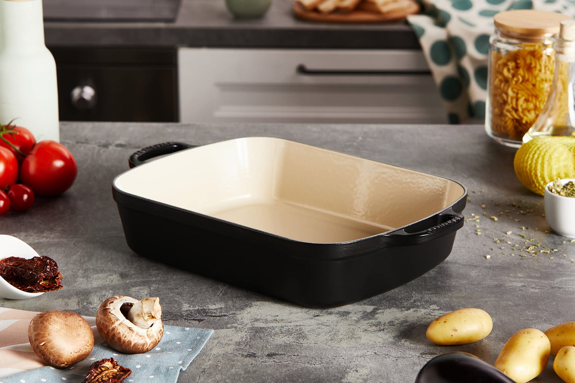 Licorice cast iron signature rectangular roaster displayed in a kitchen setting next to food