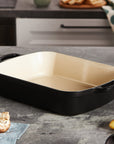 Licorice cast iron signature rectangular roaster displayed in a kitchen setting next to food