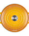 Top-down view of a round enameled cast iron Dutch oven with a matching lid, featuring bright yellow-orange handles and a silver metal knob, isolated on a white background.