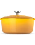 A bright yellow enameled cast iron Dutch oven with a matching lid and silver metal knob, shown on a clean white background.