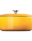 A bright yellow enameled cast iron Dutch oven with a matching lid and a silver metal knob, shown from a front-facing perspective on a solid white background.