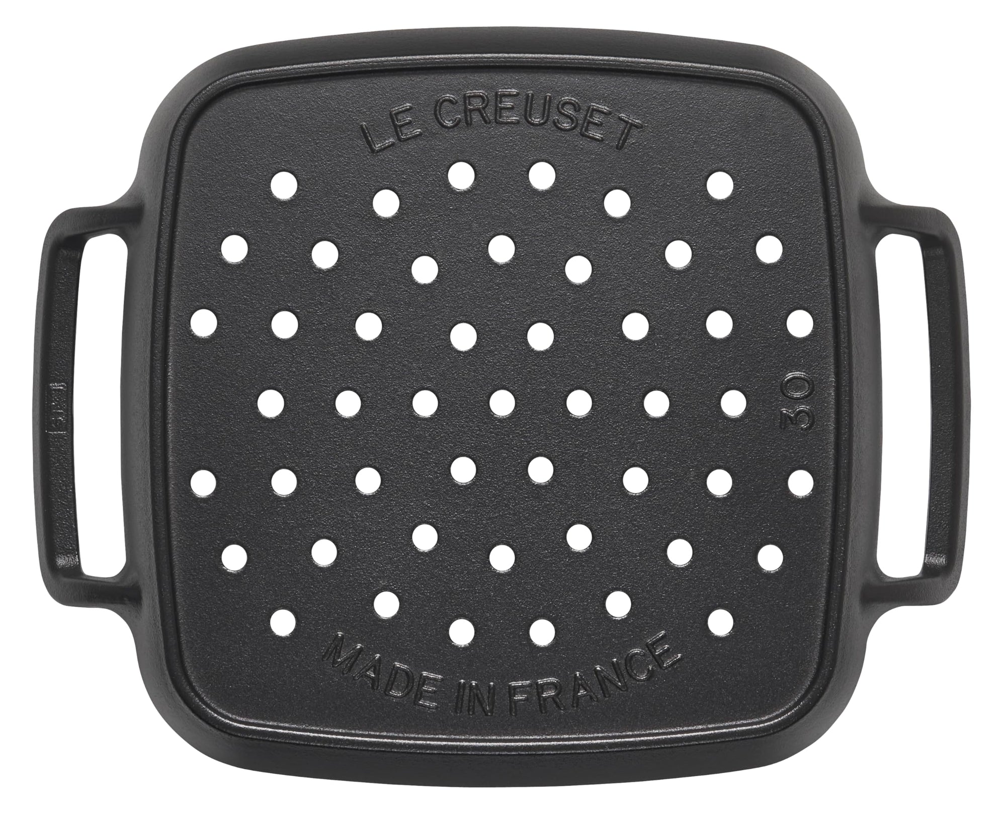Black grill pan with holes and 'Le Creuset' branding on a white background