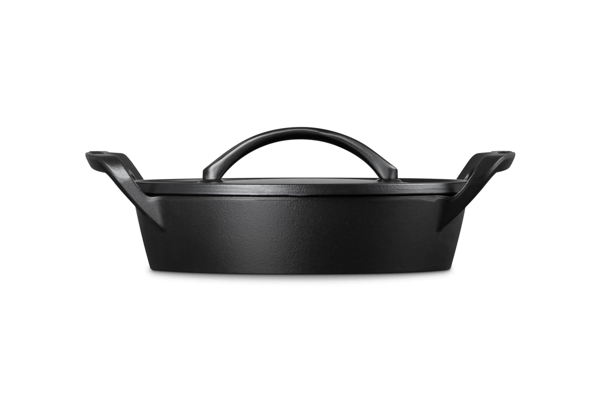 A black cast iron Dutch oven with a lid and integrated top handle, shown from a front three-quarter angle on a solid white background.