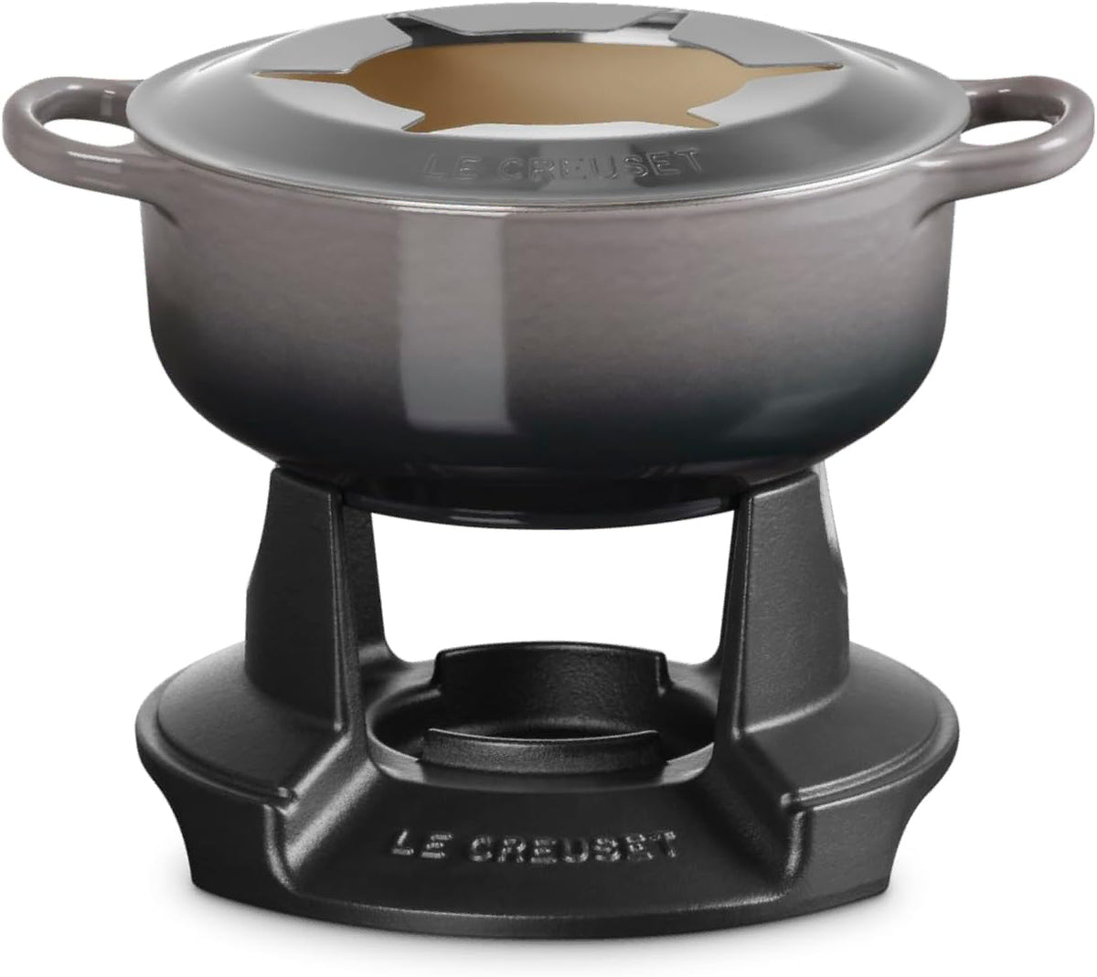 Le Creuset enameled cast iron pot with lid, shown on a black metal burner stand against a white background.