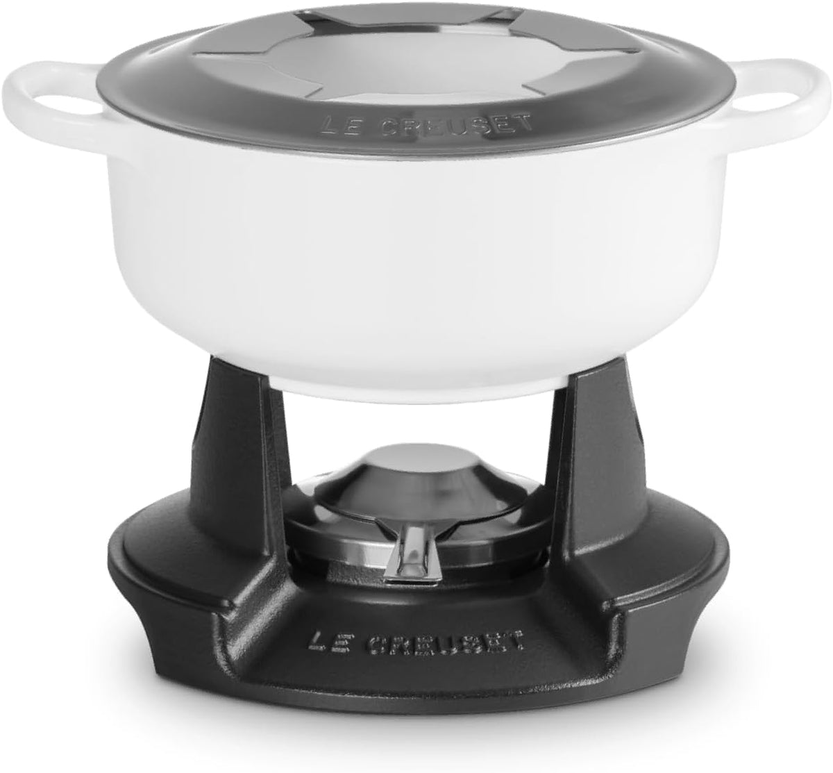 A Le Creuset white enameled cast iron pot with a dark gray lid, shown on a black Le Creuset burner base against a white background.