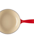 Red saucier with light interior and handle