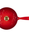 Red saucier with leaf decoration on lid with gold knob and handle
