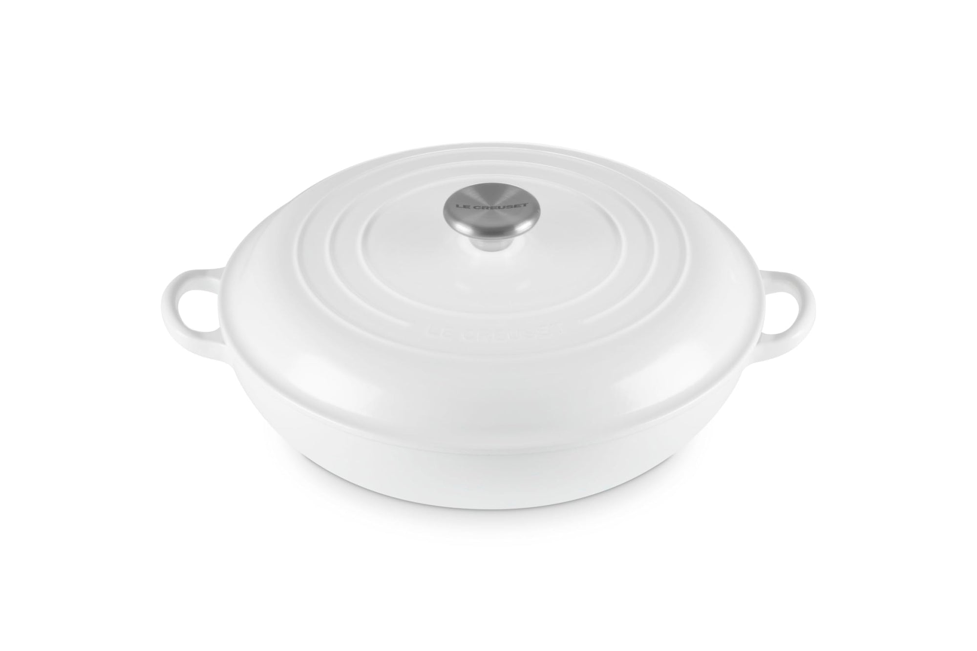 White oval ceramic braiser with lid on a white background