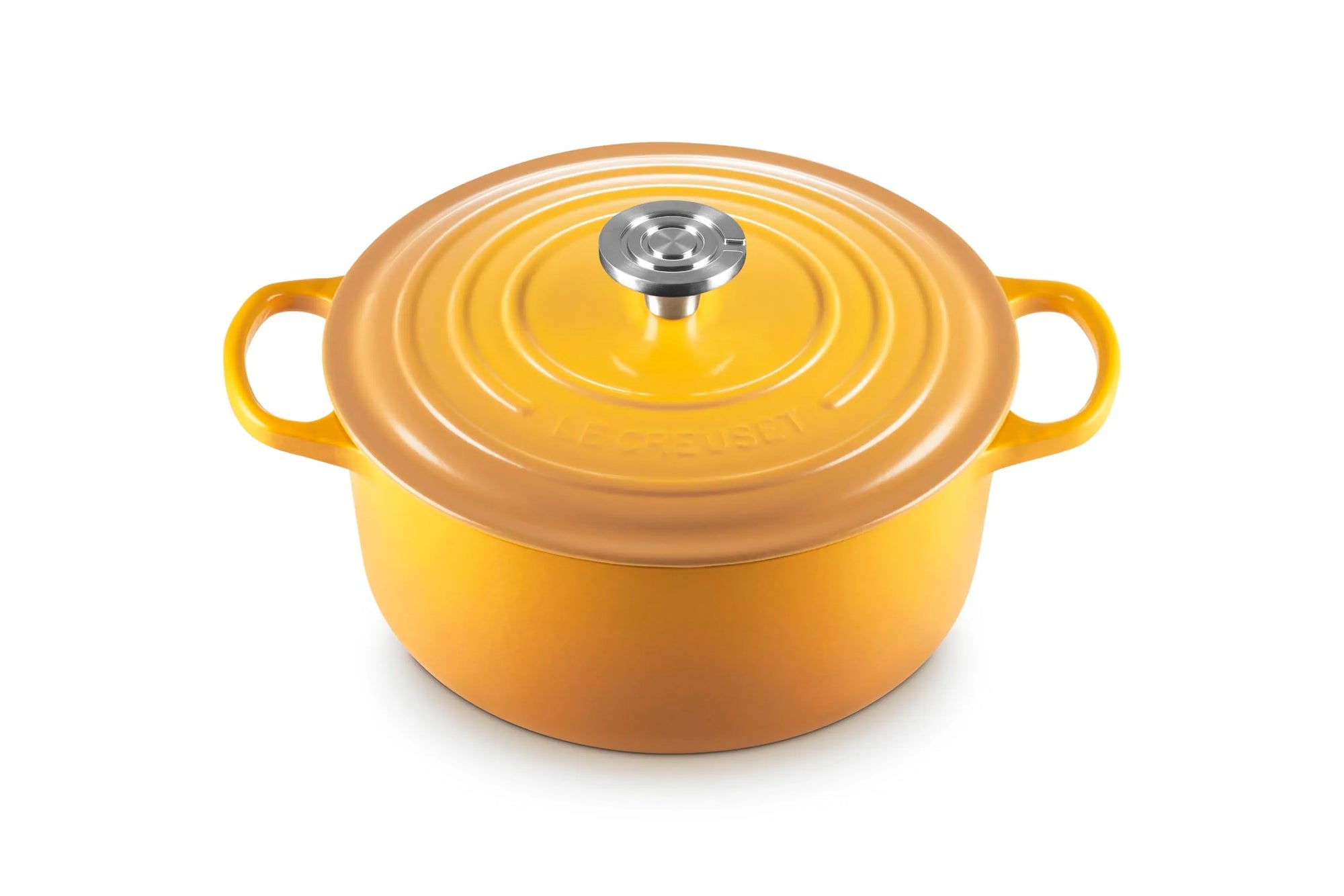 A Le Creuset enameled cast iron stockpot in a vibrant yellow-orange color, featuring a matching lid with a silver stainless steel knob, set against a plain white background.