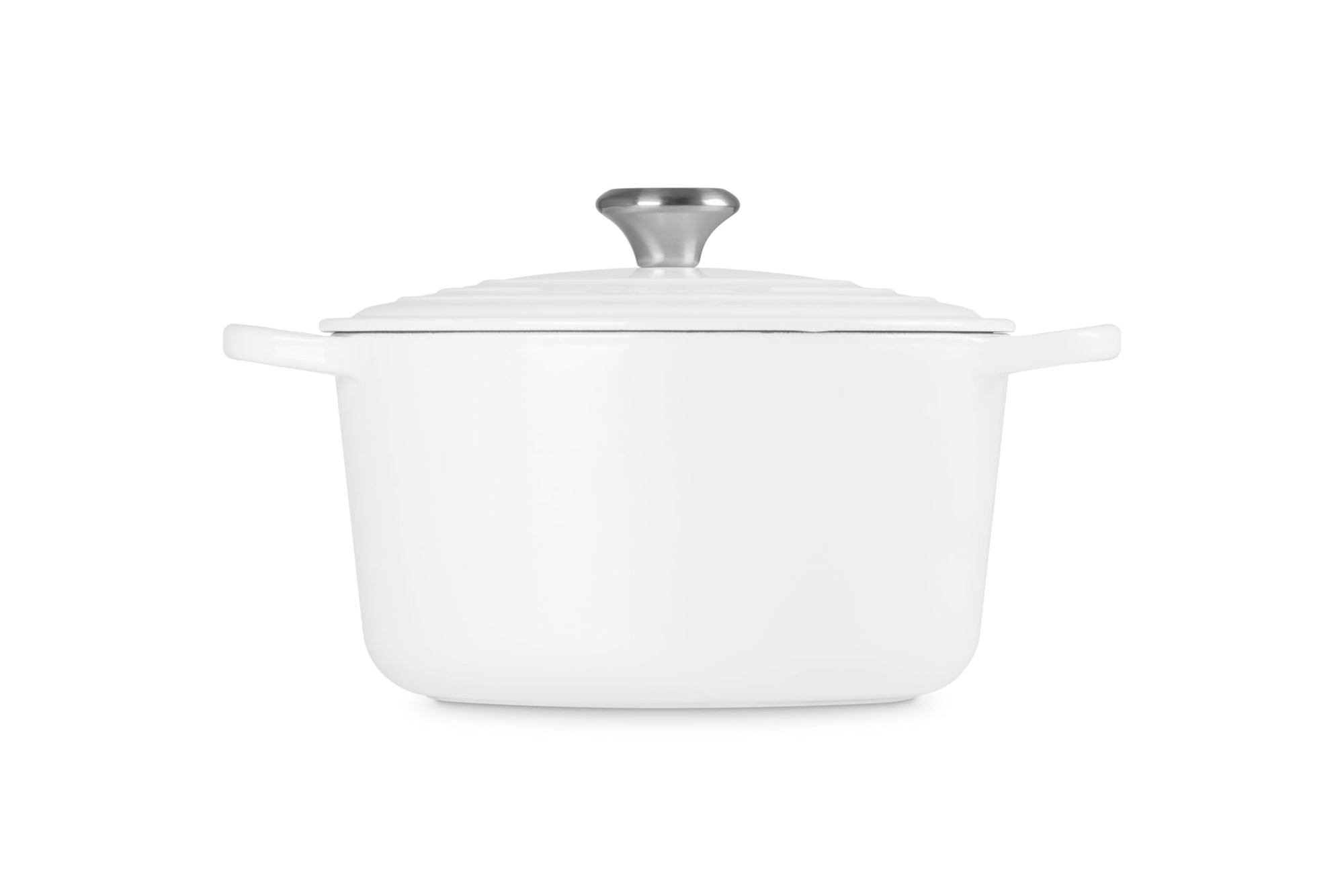 White ceramic cookware with silver lid on a white background