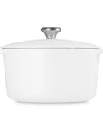 White ceramic cookware with silver lid on a white background
