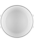 White ceramic dish with black rim on a white background