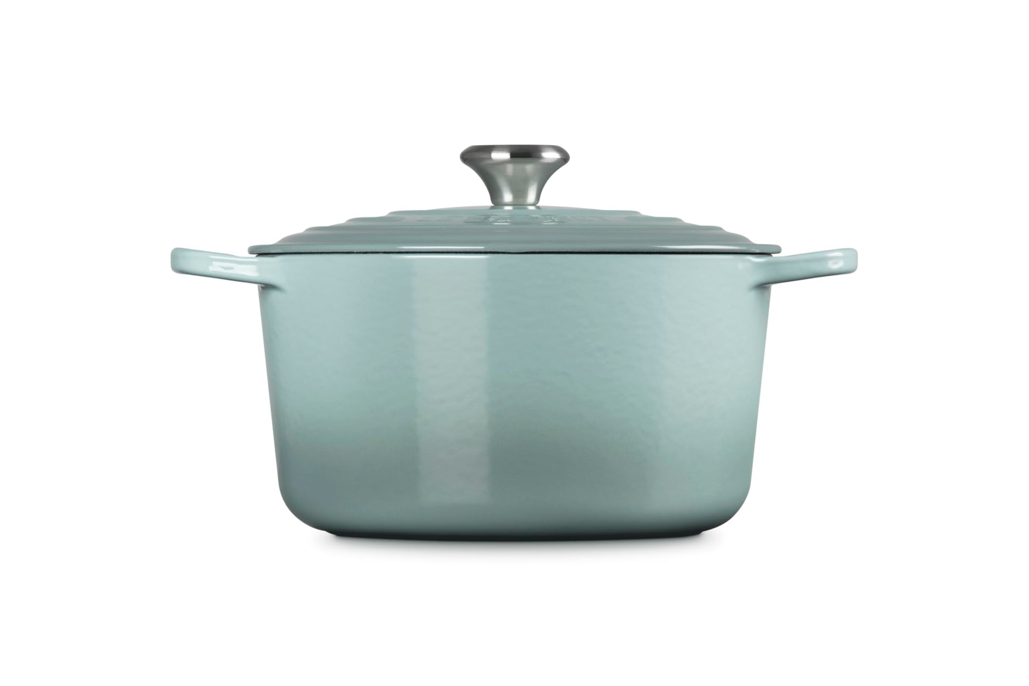 Sea salt enameled cast iron Dutch oven with a lid on a white background