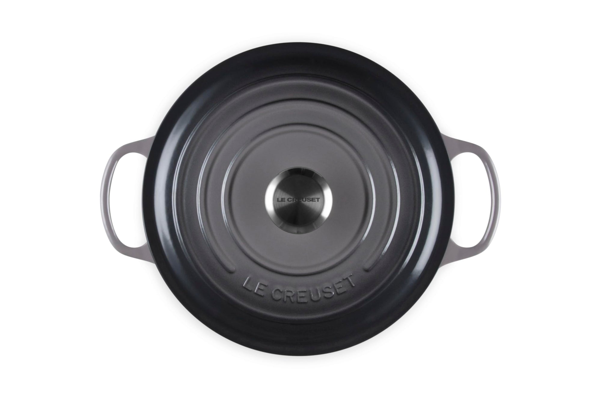 Oyster cast iron cookware with 'Le Creuset' branding on a white background
