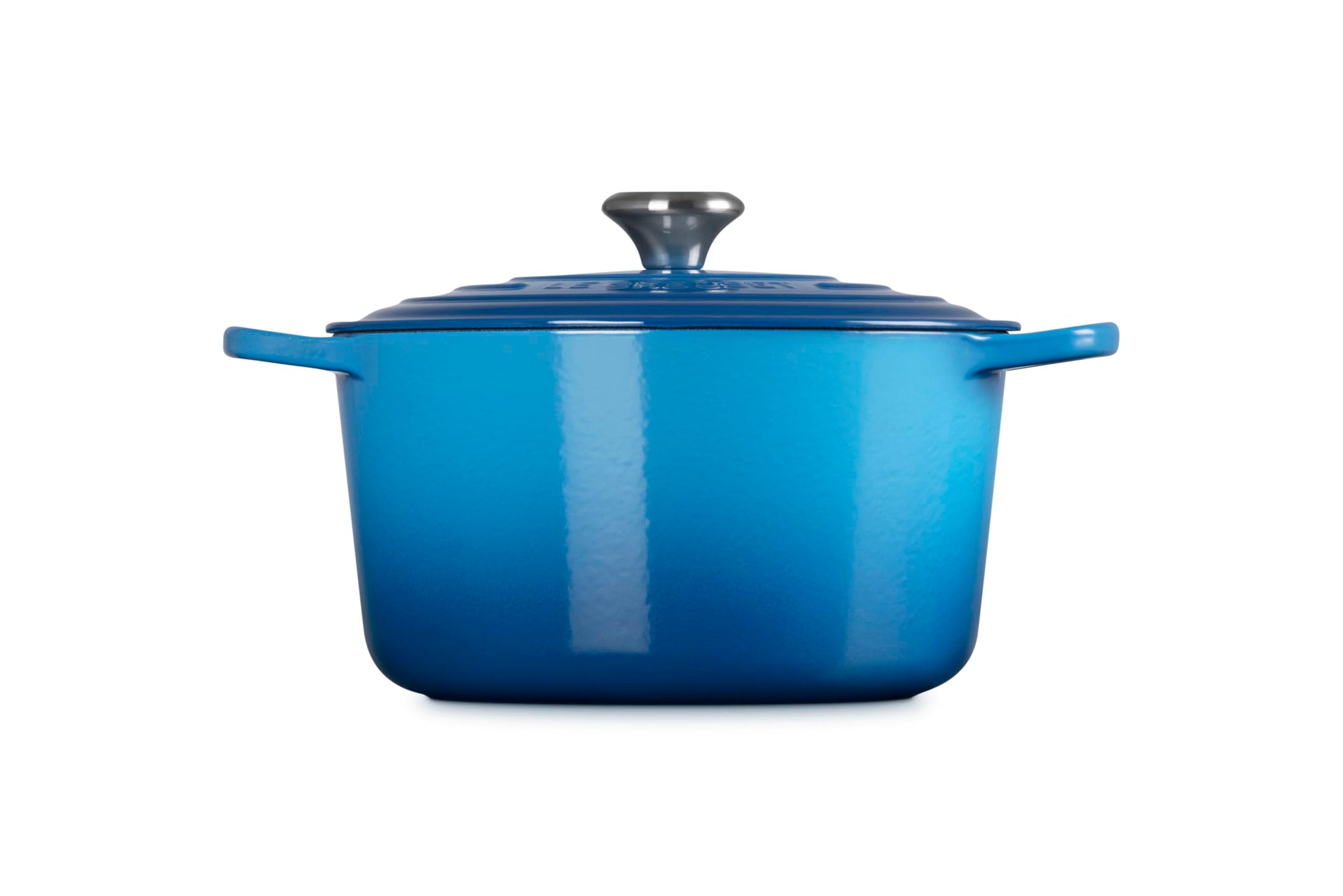 Blue enameled cast iron Dutch oven on a white background