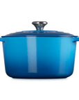 Blue enameled cast iron Dutch oven on a white background