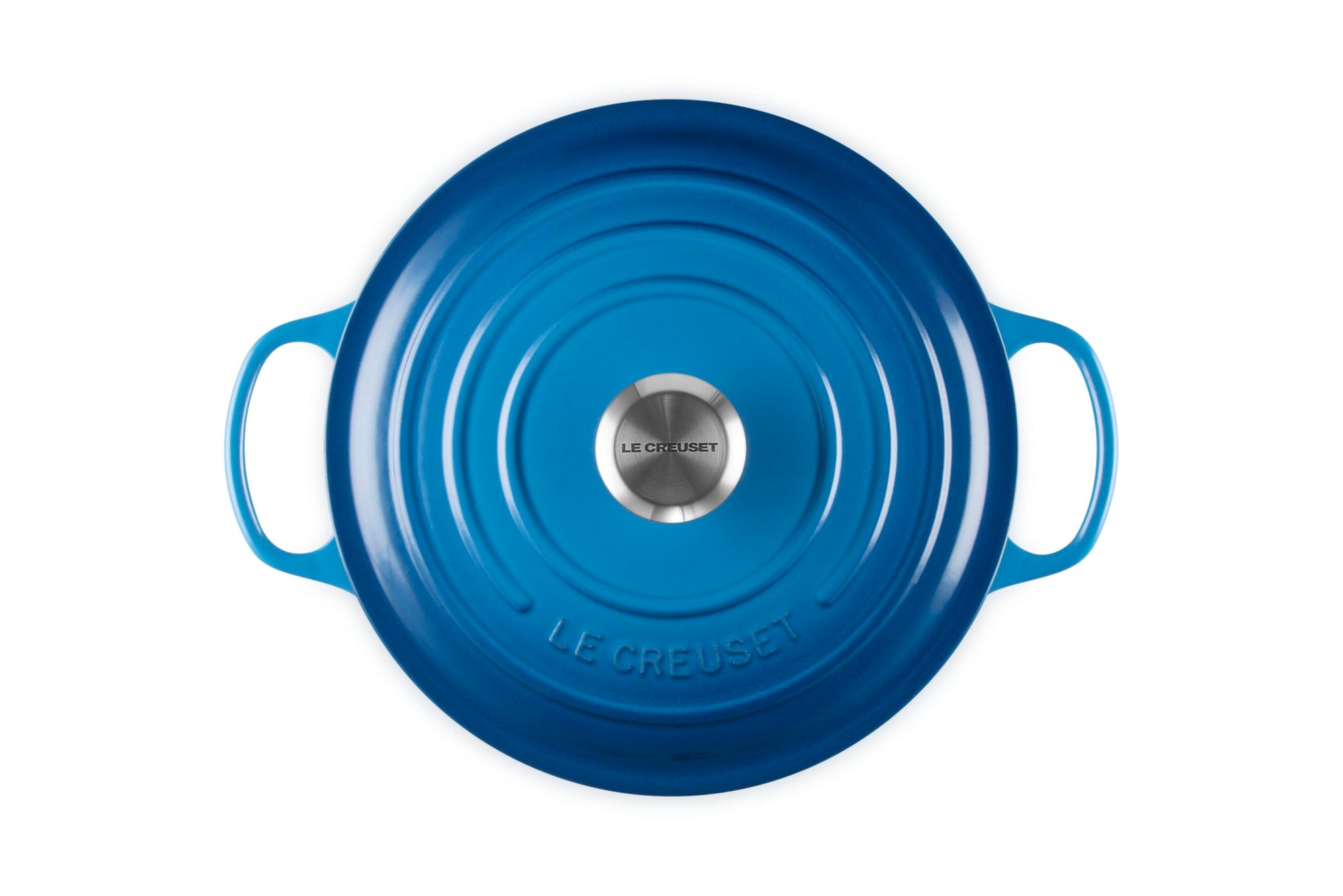 Blue round Le Creuset pot on a white background