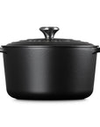 Black cast iron cookware pot with lid on a white background