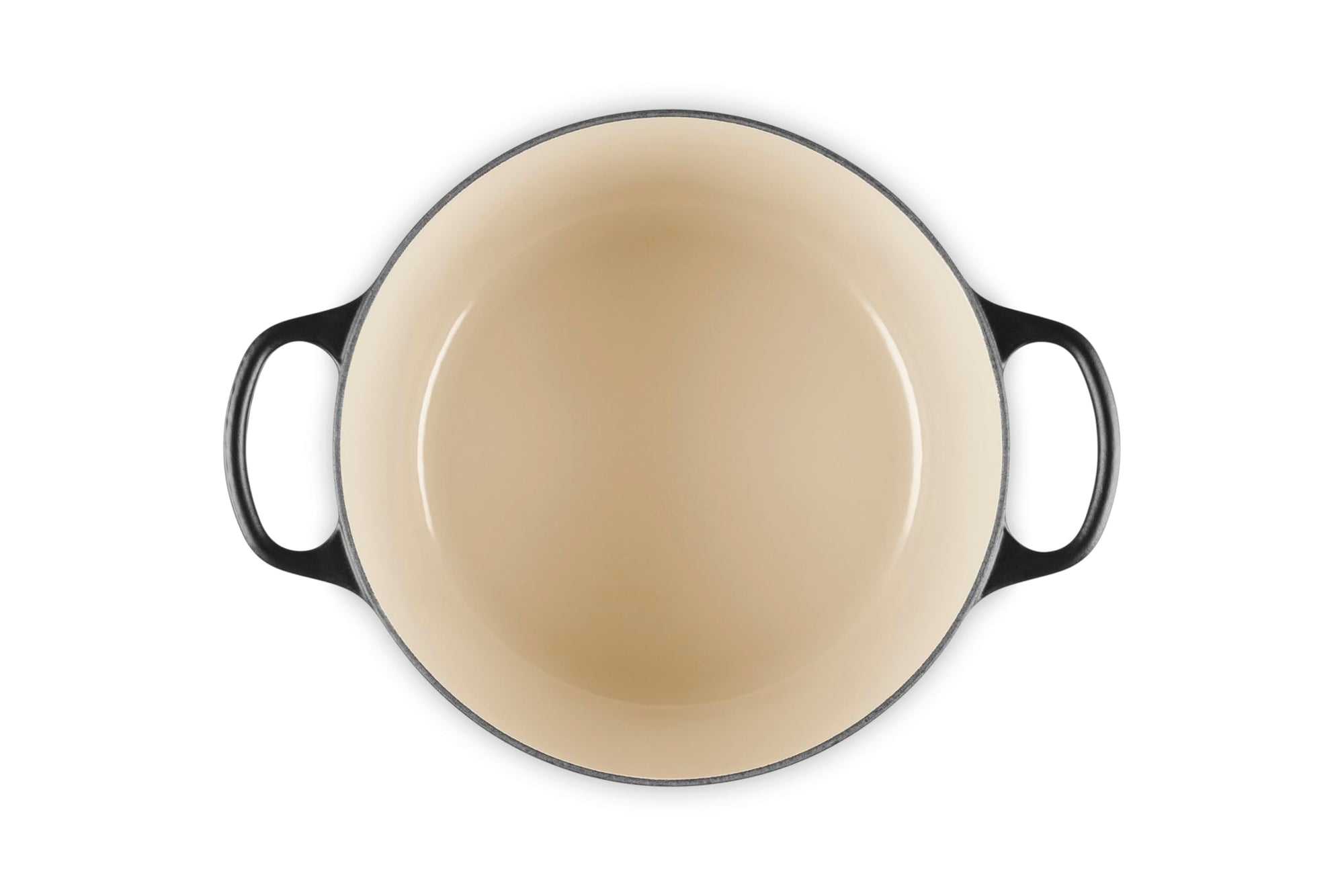 Round enameled cast iron skillet with black handles on a white background