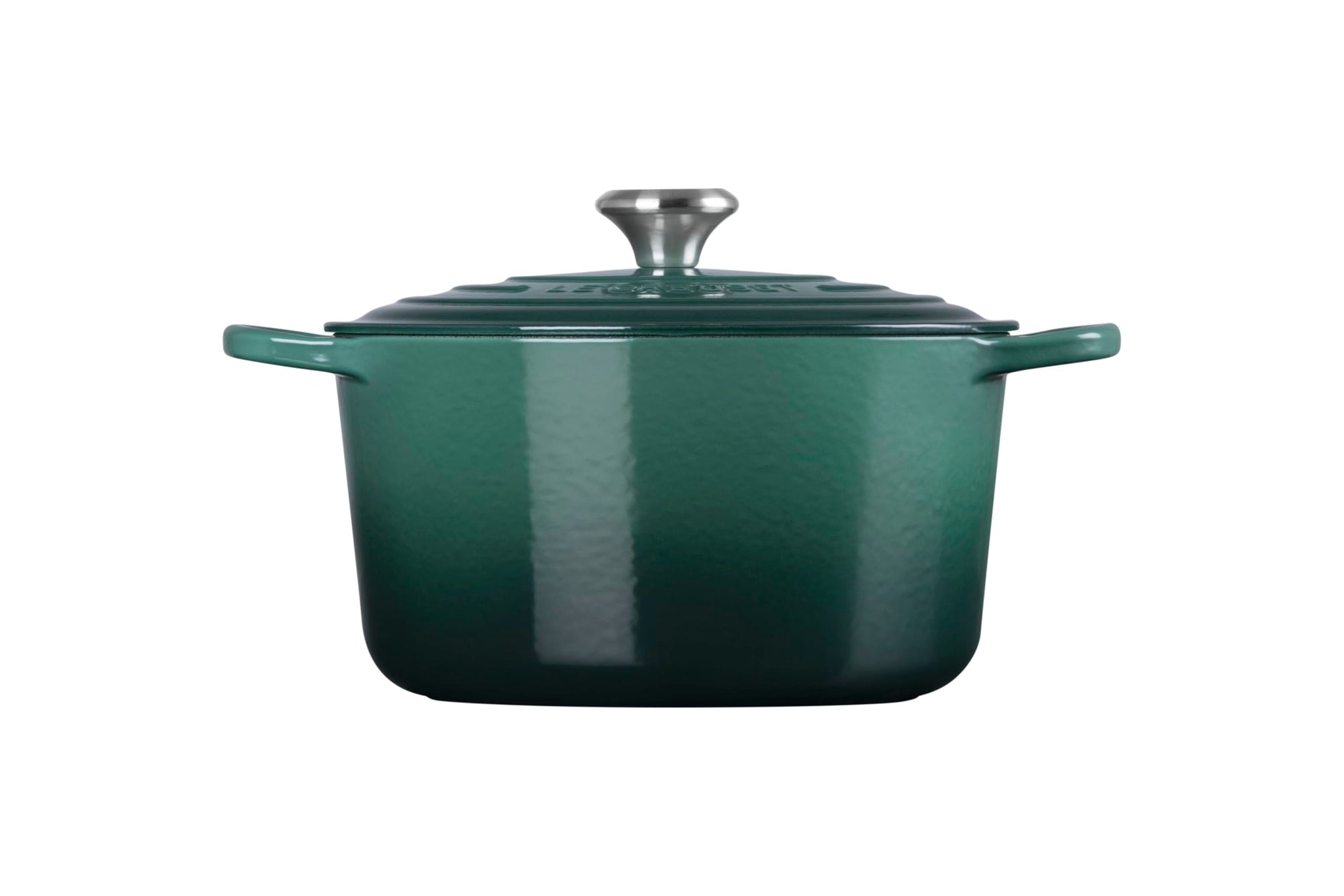 Green enameled cast iron Dutch oven with lid on a white background
