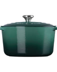 Green enameled cast iron Dutch oven with lid on a white background