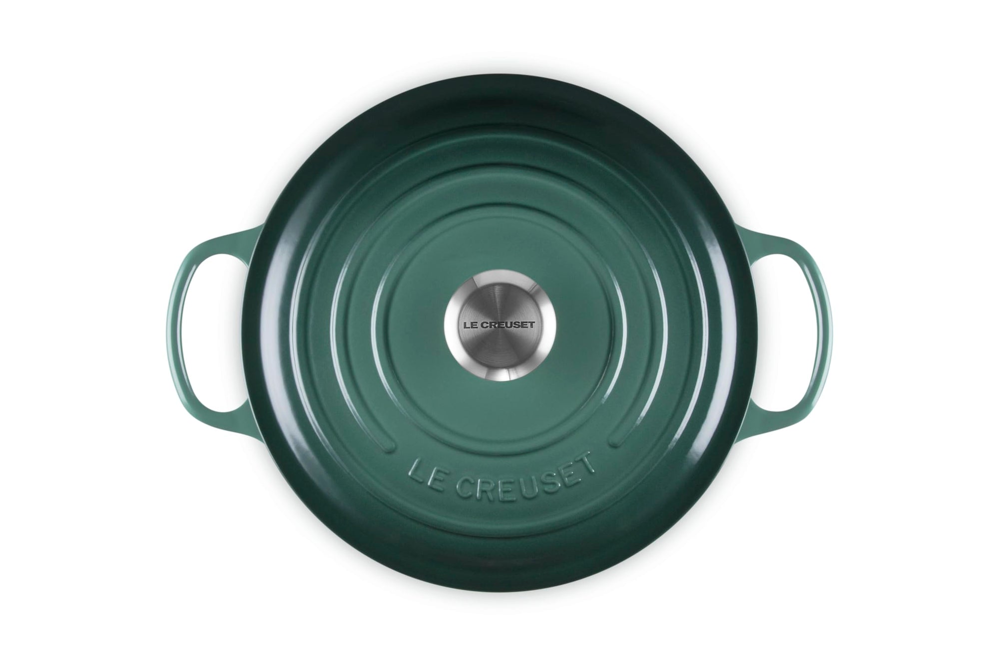 Green Le Creuset pot on a white background