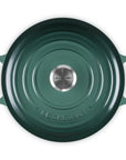 Green Le Creuset pot on a white background
