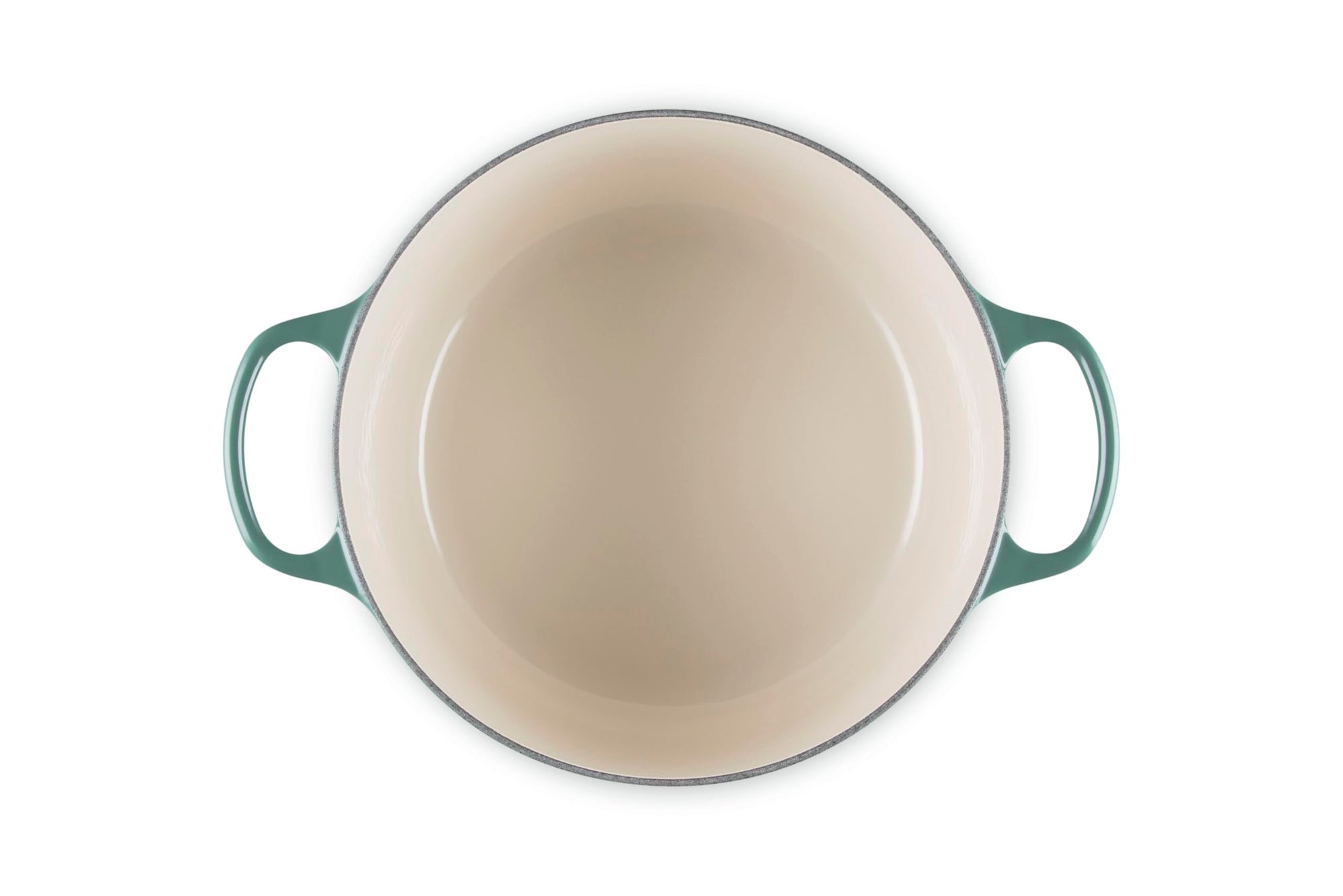 Green enameled cast iron skillet on a white background
