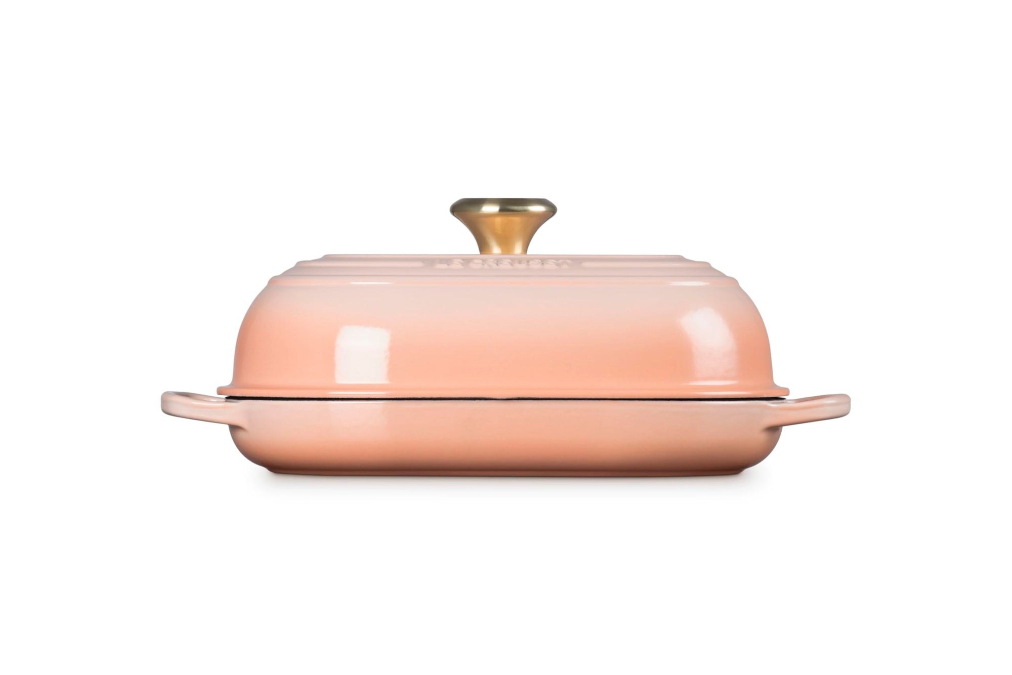 Side view of Peche bread oven pan with lid and handles displayed on a white background