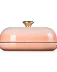 Side view of Peche bread oven pan with lid and handles displayed on a white background