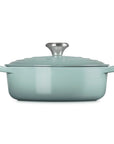 Side view of 3.5 qt Sea salt Le Creuset Signature Round Wide Dutch Oven with a lid displayed on a white background