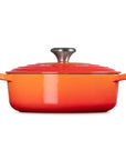 Side view of 3.5 qt flame Le Creuset Signature Round Wide Dutch Oven with a lid displayed on a white background