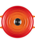 Top view of 3.5 qt flame Le Creuset Signature Round Wide Dutch Oven with a lid displayed on a white background