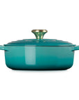 Side view of 3.5 qt riviera Le Creuset Signature Round Wide Dutch Oven with a lid displayed on a white background