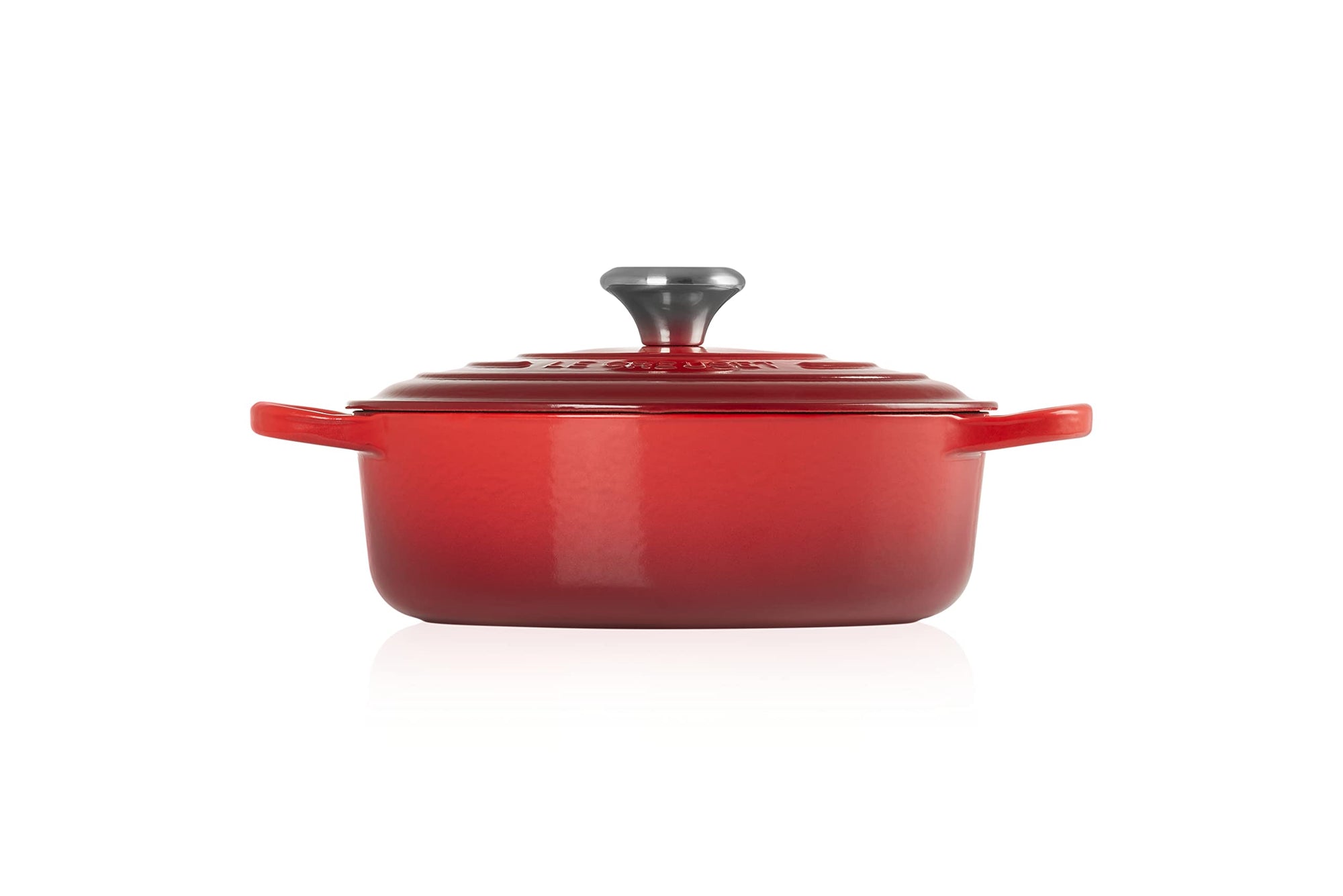 Side view of 3.5 qt cerise Le Creuset Signature Round Wide Dutch Oven with a lid displayed on a white background