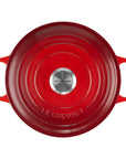 Top view of 3.5 qt cerise Le Creuset Signature Round Wide Dutch Oven with a lid displayed on a white background