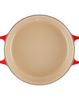 Top view of 3.5 qt cerise Le Creuset Signature Round Wide Dutch Oven displayed on a white background