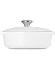 Side view of 3.5 qt white Le Creuset Signature Round Wide Dutch Oven with a lid displayed on a white background