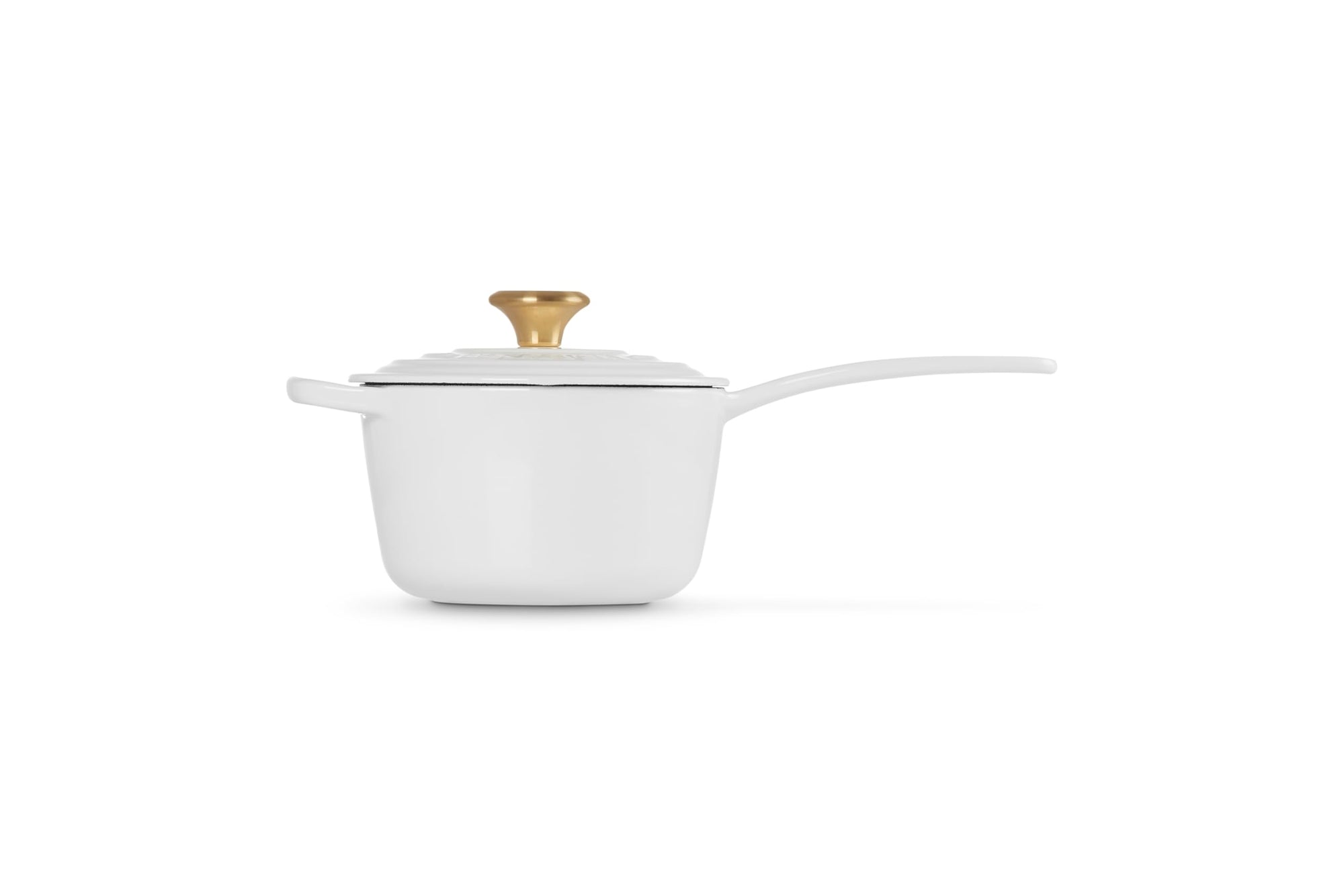 White saucepan with a gold lid knob on a white background