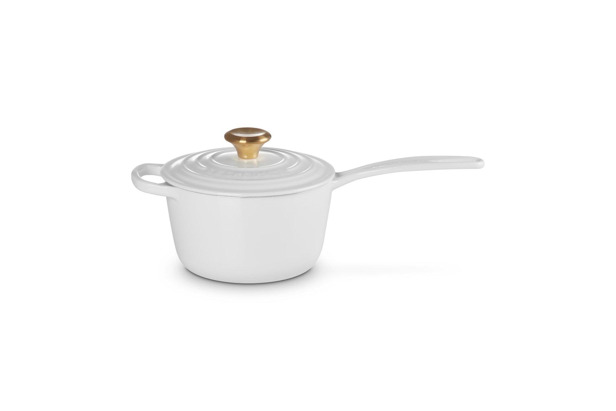 White enameled cast iron cookware with a gold lid knob on a white background