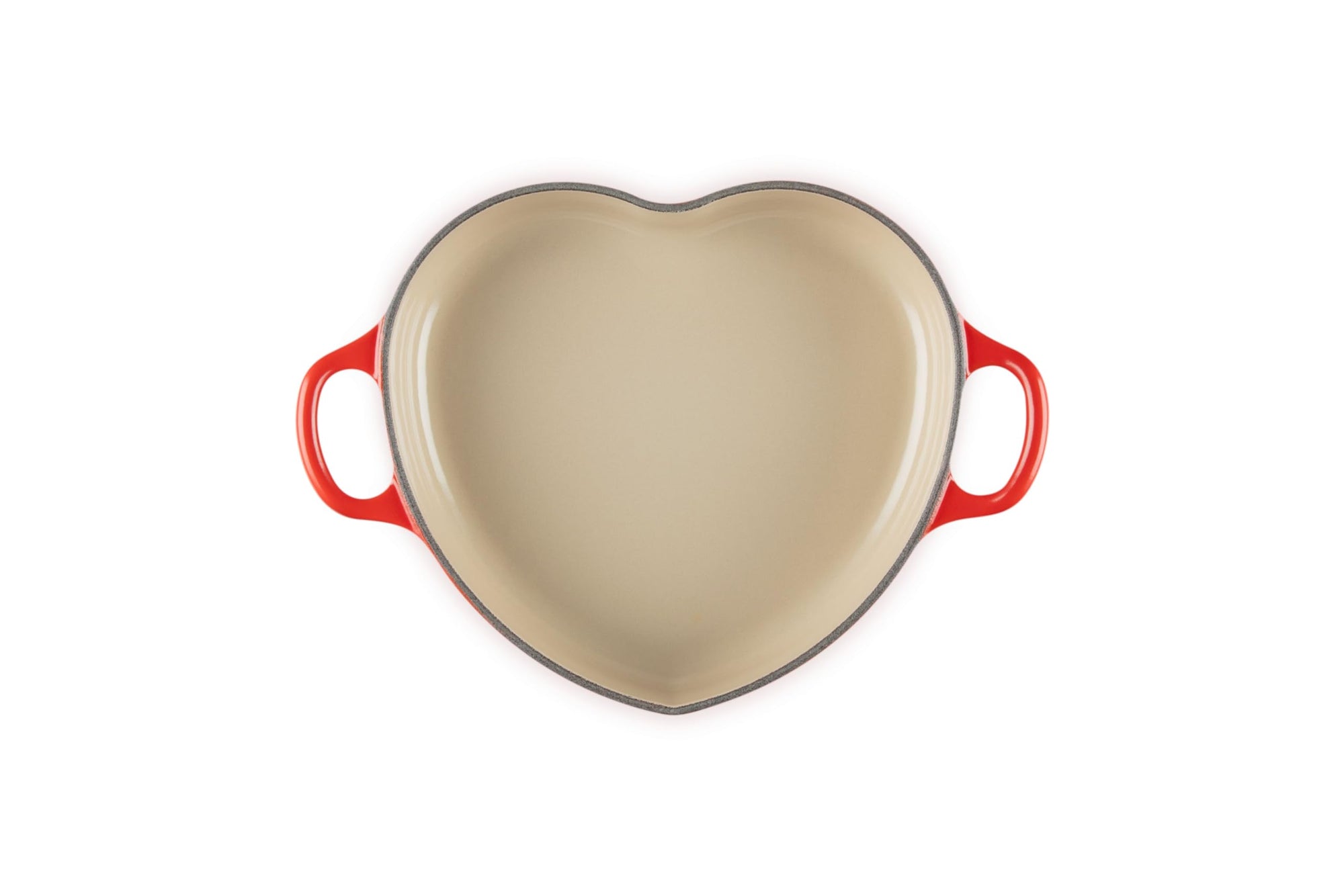 Top view of cerise heart shaped 1.25 qt cocotte with handles displayed on a white background